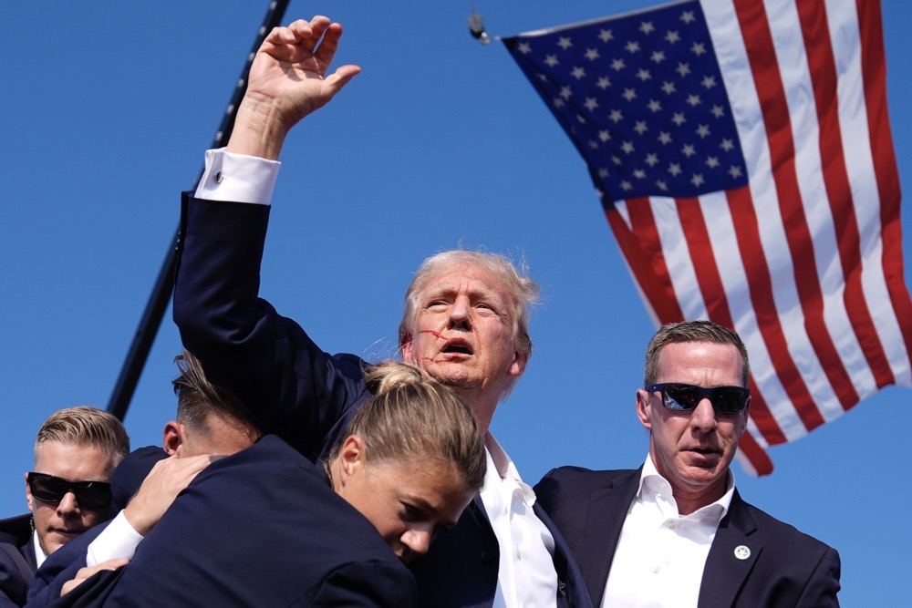 Republican presidential candidate former President Donald Trump is surrounded by U.S. Secret Service agents at a campaign rally, Saturday, July 13, 2024, in Butler, Pa. (AP)
