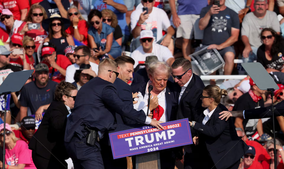 Republican presidential candidate and former US President Donald Trump is assisted by US Secret Service personnel after gunfire rang out during a campaign rally at the Butler Farm Show in Butler, Pennsylvania, US, July 13, 2024. (Reuters)