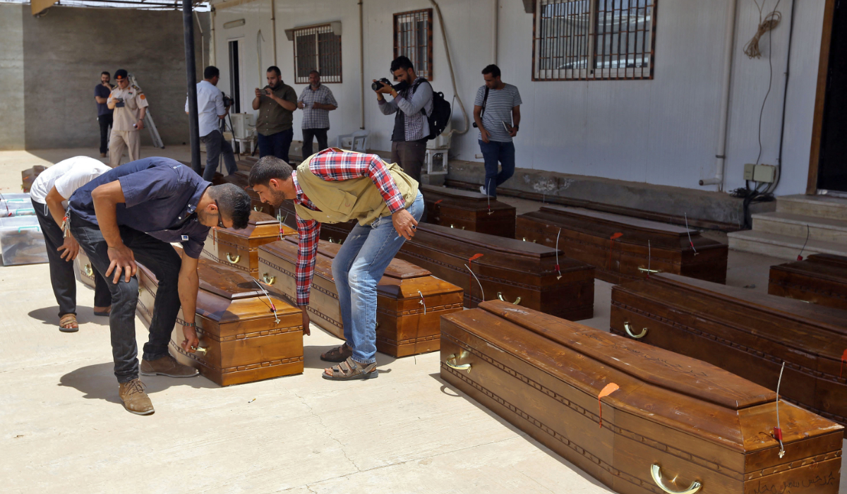 Coffins containing the remains of 20 Egyptian Coptic Christians beheaded by Daesh militants in Sirte, Libya, in 2015, are brought out of a criminal investigations office in Misrata for repatriation to Egypt on May 14, 2018. (AFP file photo)
