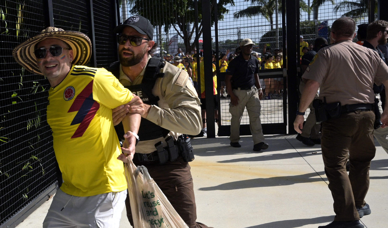 Security personnel detain a Colombia supporter that tried to get into the stadium without tickets ahead of the 2024 Copa America final between Argentina and Colombia at the Hard Rock Stadium, in Miami, Florida on July 14, 2024. (AFP/File)