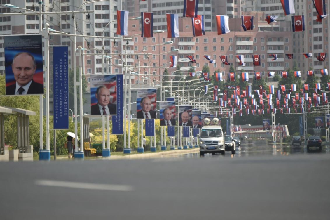 Portraits of Russian President Vladimir Putin are seen near national flags of North Korea and Russia in Pyongyang on June 20, 2024, displayed for Putin's summit with North Korea's Kim Jong Un where he won a pledge of "full support" on Ukraine and signed a mutual defence pact. (AFP)