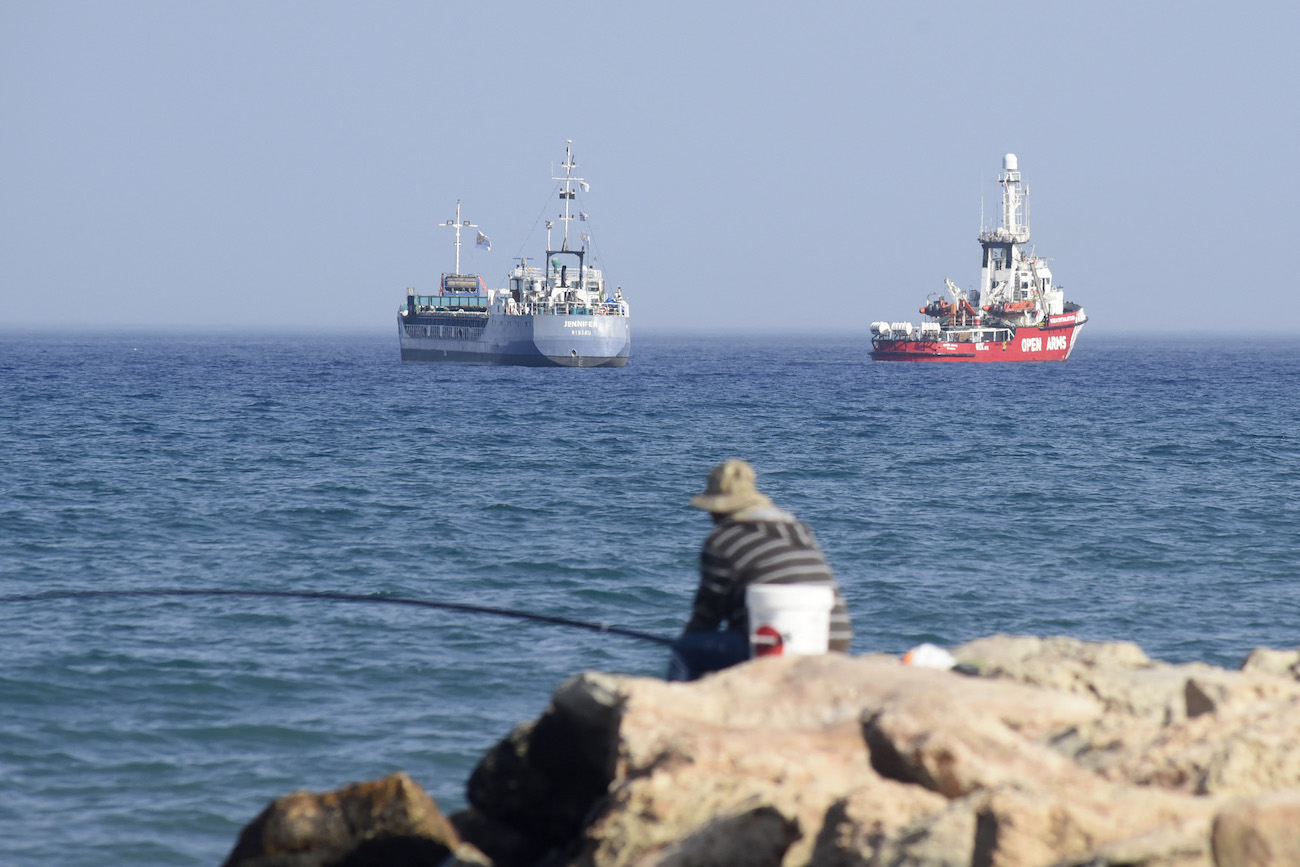 An Open Arms ship and ship Jennifer, of the World Central Kitchen carrying food aid for the Gaza Strip, prepare to set sail close to the port of Larnaca in Cyprus on March 30, 2024. (File/AFP)