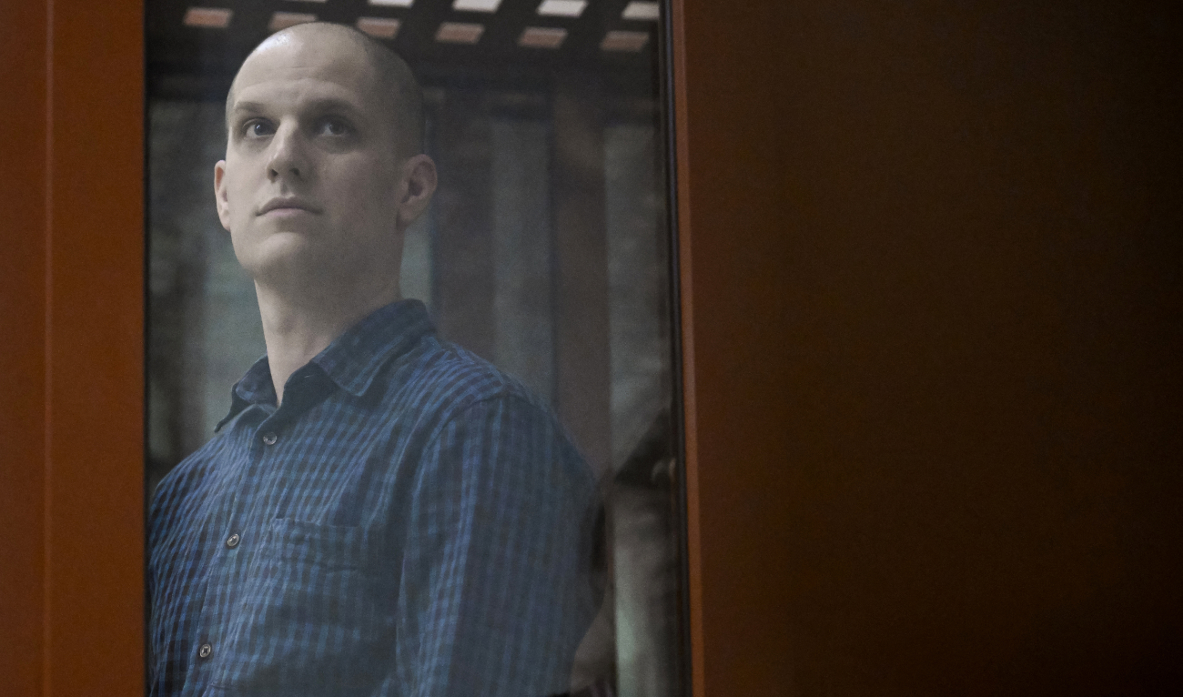 US journalist Evan Gershkovich, accused of espionage, looks out from inside a glass defendants' cage prior to a hearing in Yekaterinburg's Sverdlovsk Regional Court on June 26, 2024. (AFP)