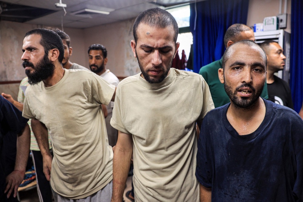 Men who were detained by Israel during the military operation in Rafah react after their release, at the Aqsa Martyrs Hospital in Deir el-Balah in the central Gaza Strip. (AFP)