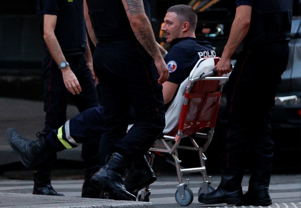 A member of police sits on a wheelchair after a police officer was injured in an attack next to the Champs-Elysees avenue, in Paris. (Reuters)