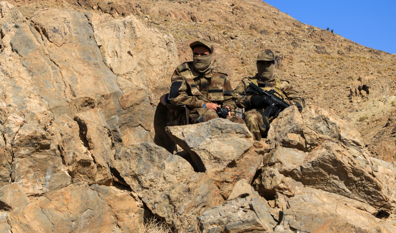 Afghan security personnel sit guard at the inauguration ceremony of an iron ore mine, at Ghorian district in Herat province on November 9, 2023. (AFP/File)