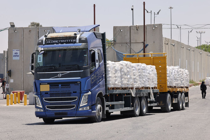 A truck carrying humanitarian aid for the Gaza Strip drives at the Kerem Shalom (Karm Abu Salem) border crossing between southern Israel and Gaza. (File/AFP)