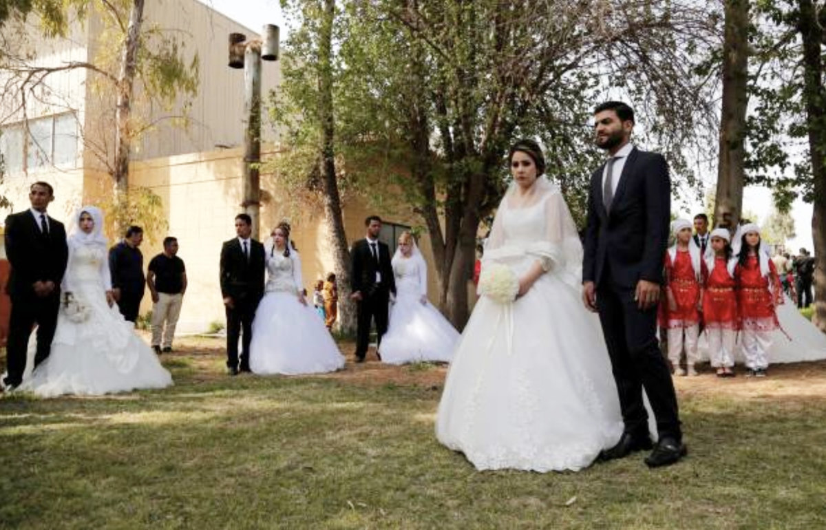 Grooms and brides are seen during a mass wedding ceremony that organized by Barzani Charity Foundation in Iraqi Kurdish Regional Government's Irbil, Iraq on April 07, 2017. (Anadolu Agency/Getty Images)