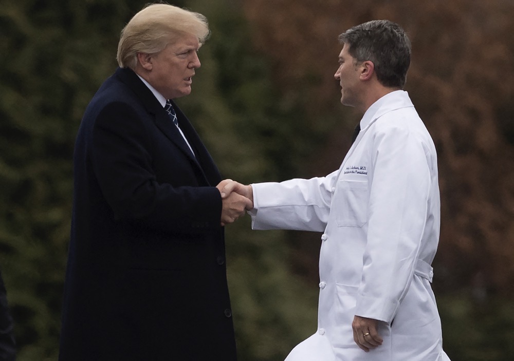 US President Donald Trump shakes hands with White House Physician Rear Admiral Dr. Ronny Jackson, following his annual physical at Walter Reed National Military Medical Center in Bethesda, Maryland, January 12, 2018. (AFP/File)
