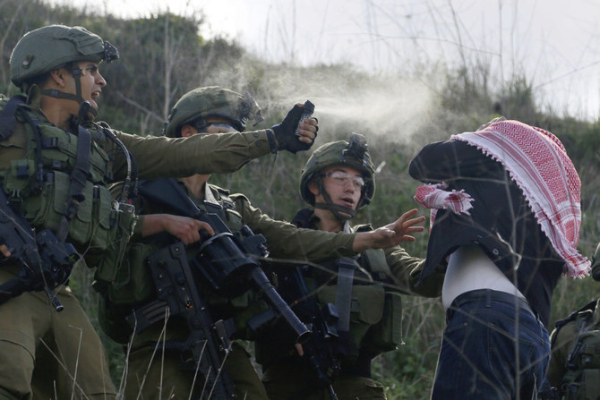 This file photo shows Israeli soldiers pepper spraying a Palestinian demonstrator near the Jewish settlement Yitzhar, near the West Bank city of Nablus. The top UN court on July 19, 2024 said that Israel's presence in the Palestinian occupied territories is "unlawful." (AP)