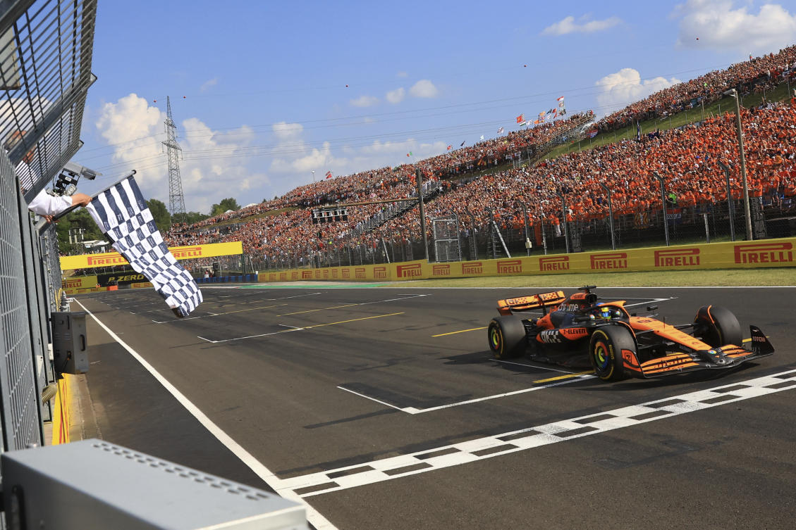 McLaren driver Oscar Piastri of Australia crosses the finish line to win the Hungarian Formula One Grand Prix race at the Hungaroring racetrack in Mogyorod, Hungary, Sunday, July 21, 2024. (AP)