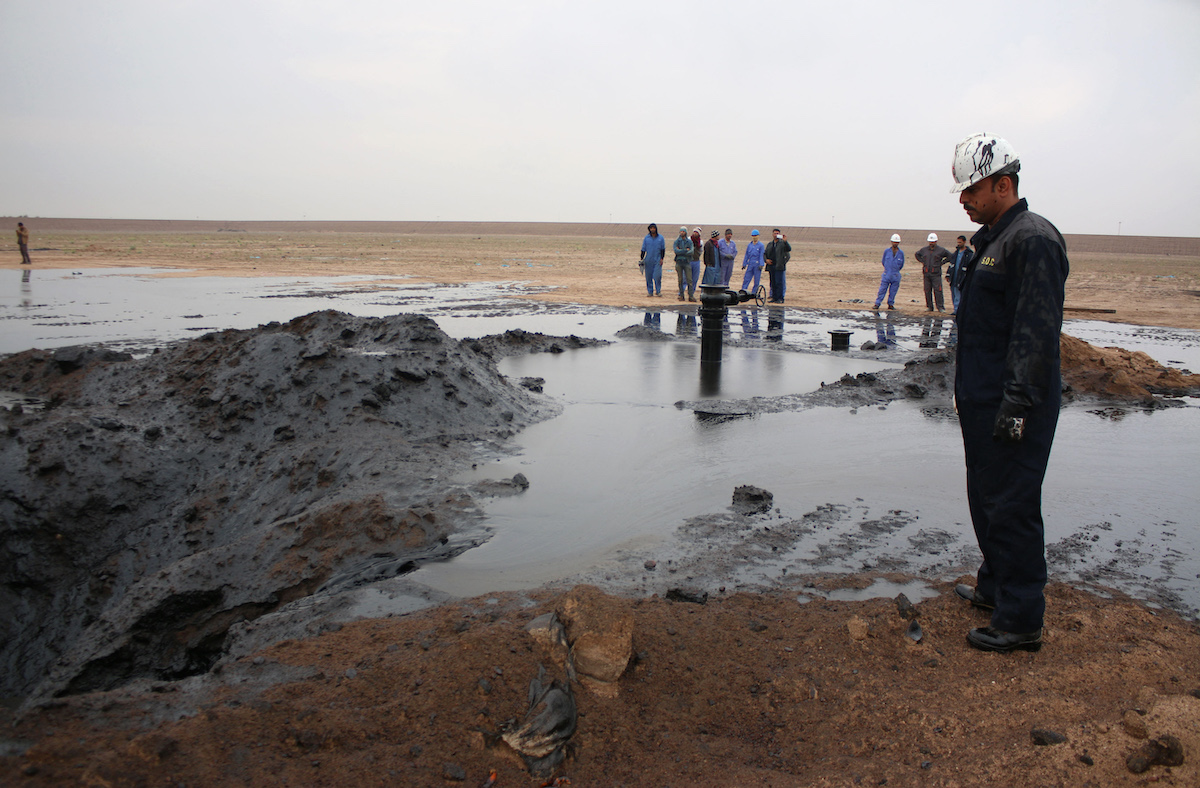 Workers from the South Oil Company stand at the site of one of the companies two new wells, in Tuba oilfield West of Iraq's second largest city of Basra. (File/AFP)