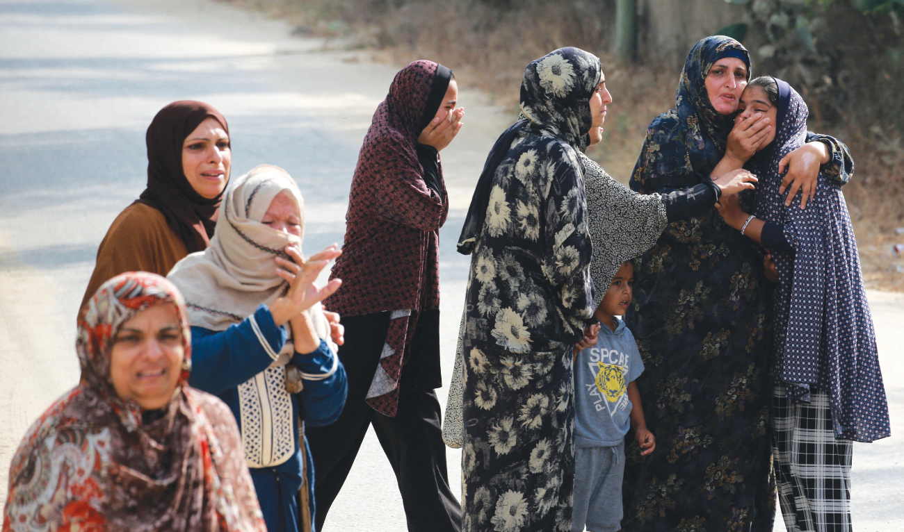 Palestinians mourn the death of relatives in Khuzaa in the Gaza Strip. (AFP)