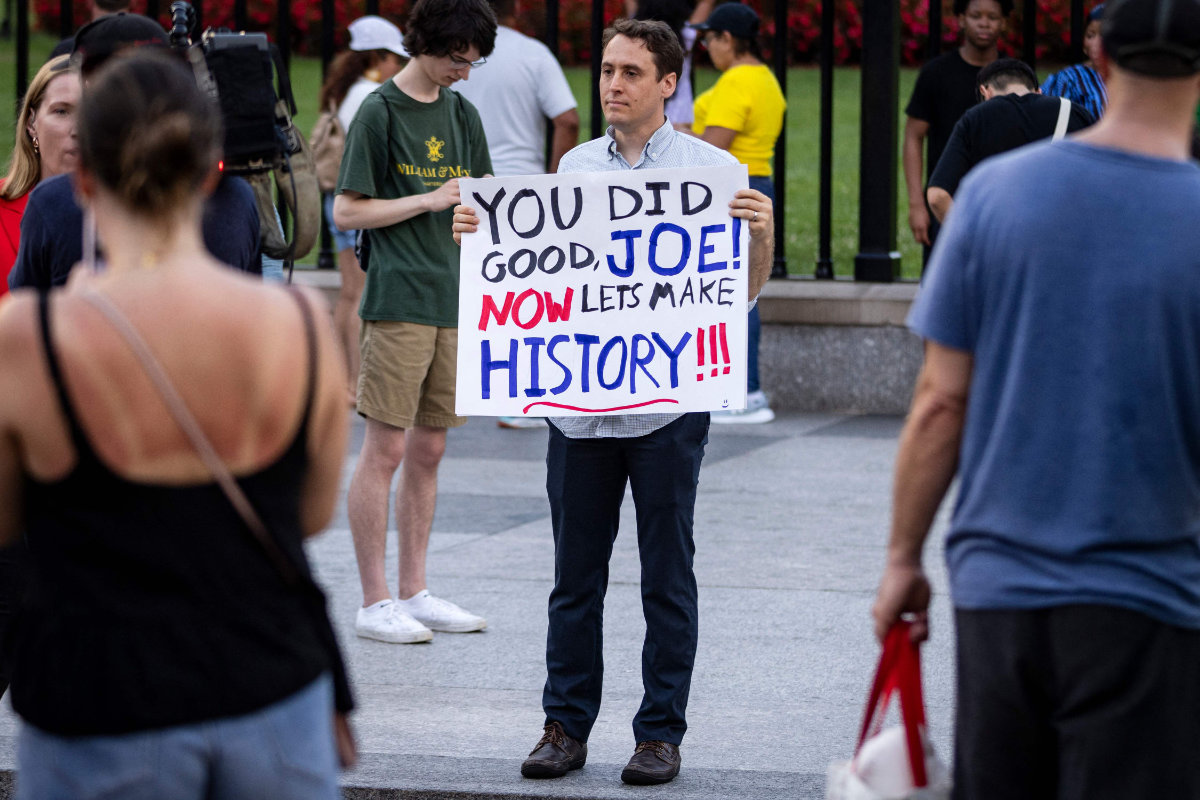 A man holds a sign showing his appreciation for US President Joe Biden along Pennsylvania Avenue in front of the White House in Washington, DC, on July 21, 2024. (AFP)