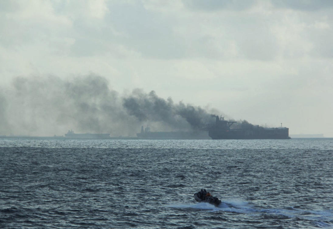 Above, a rigid-hulled inflatable boat in the vicinity of the burning vessels who were involved in a collision about 55km northeast of the Singaporean island of Pedra Branca on July 19, 2024. (Singapore Navy via Reuters)