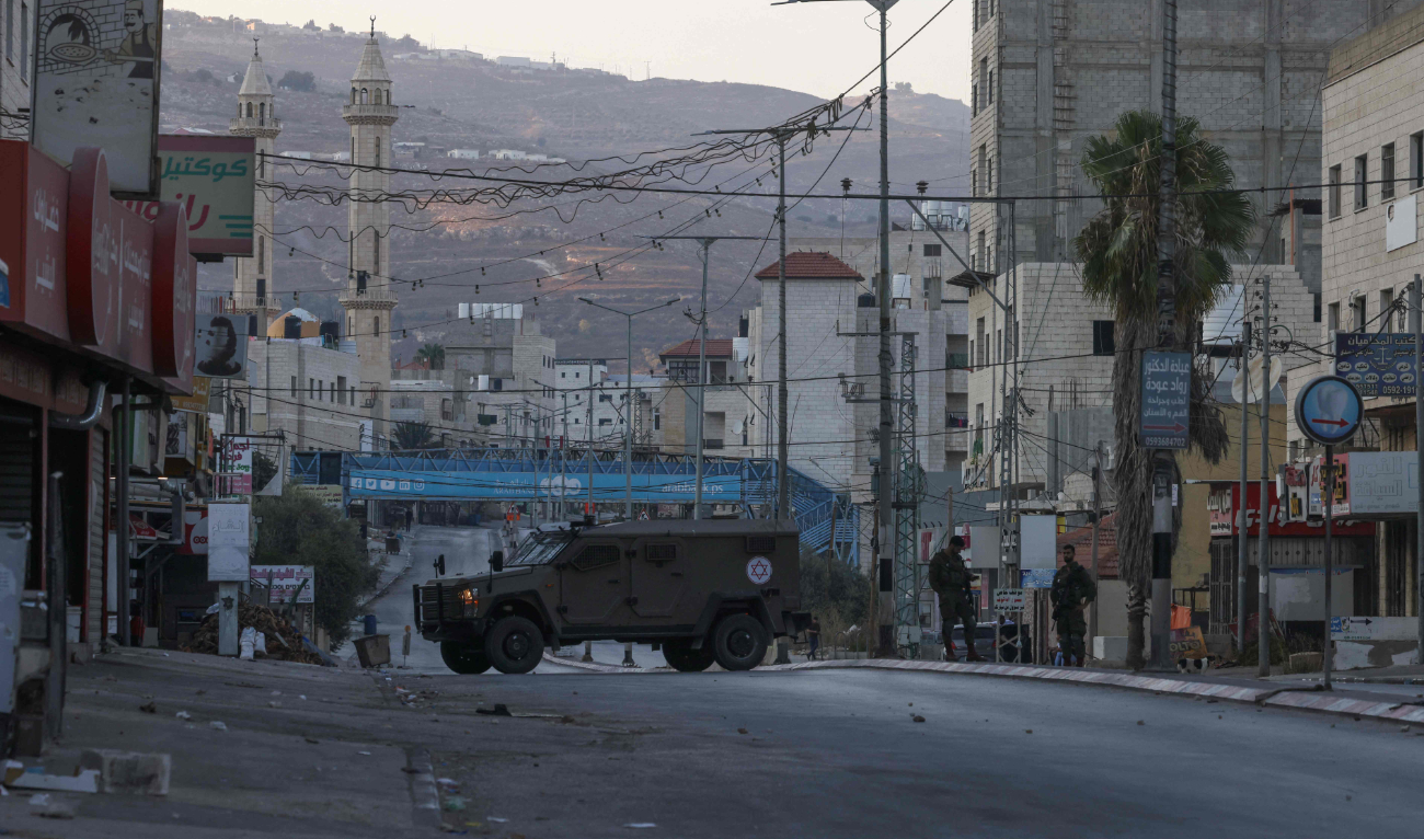 Israeli security forces close off a main entrance to Huwara town in the occupied West Bank following reported attacks by extremist settlers. (File/AFP)