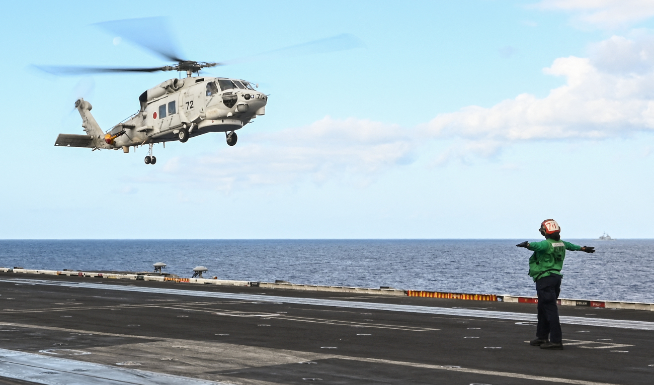 A Japan Maritime Self-Defense Force SH-60K helicopter lands on the deck of the USS Carl Vinson aircraft carrier during a three-day maritime exercise between the US and Japan in the Philippine Sea on January 31, 2024. (AFP/File)