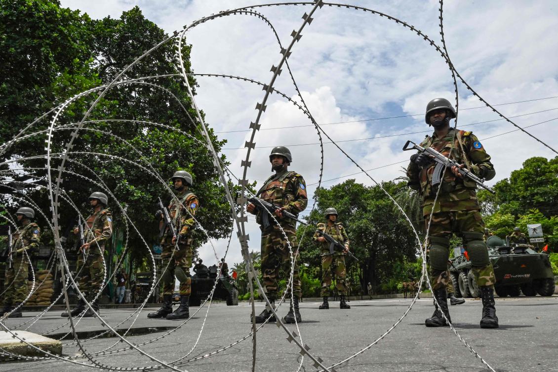 There is a heavy military presence in Dhaka, with bunkers set up at some intersections and key roads blocked with barbed wire after a curfew was imposed. (AFP)