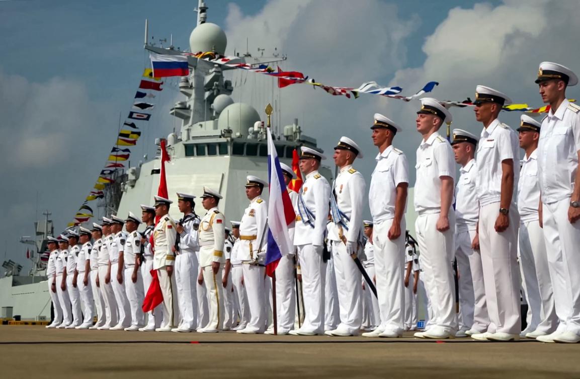 A grab taken from a handout footage released by the Russian Defence Ministry on July 15, 2024, shows Russian and Chinese sailors taking part in the opening ceremony of a joint maritime exercises at a port in Zhanjiang in China's southern Guangdong province. (File/AFP)