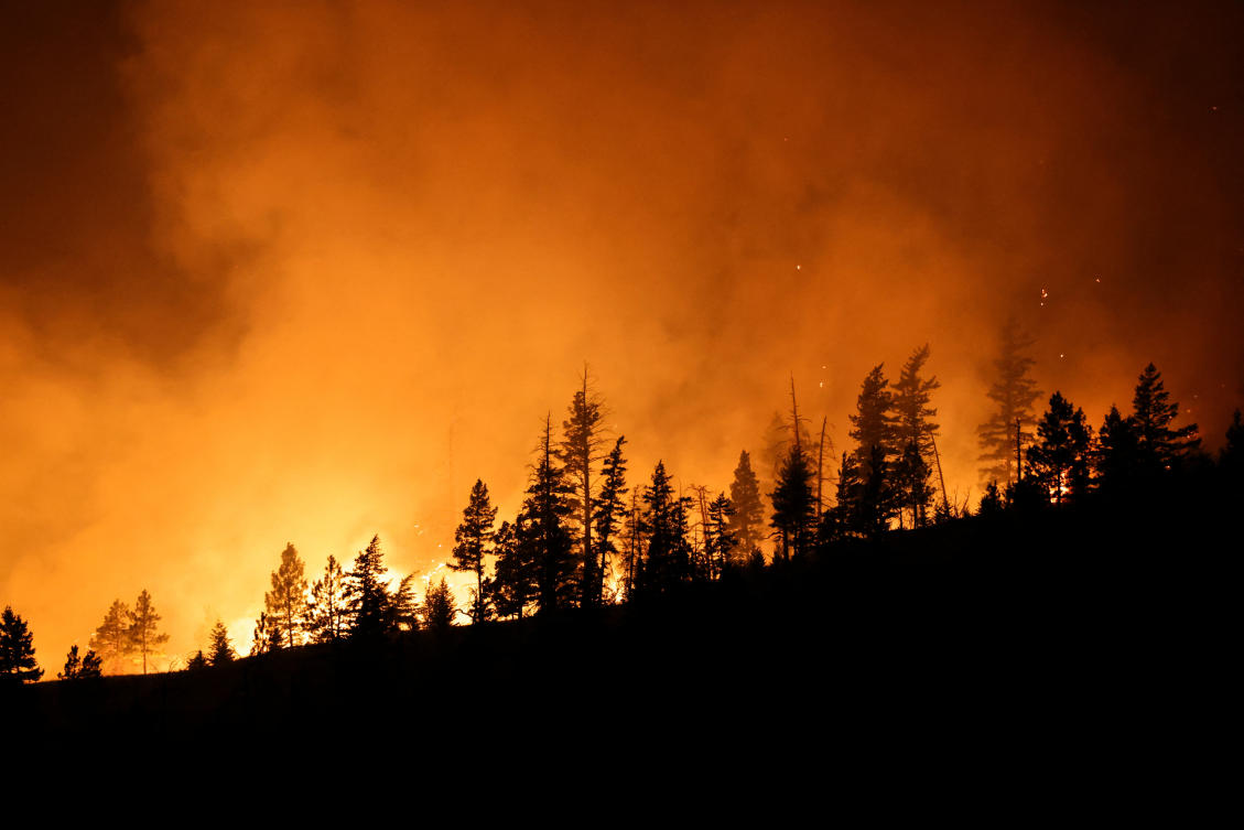 Flames from the Shetland Creek wildfire are seen from Highway 1 outside Ashcroft, British Columbia, Canada, where 2,000 people are on evacuation alert in the province’s southern interior, Jul. 19, 2024. (Reuters)