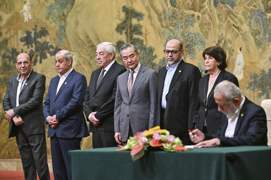 China’s Foreign Minister Wang Yi, fourth left, looks on, while hosting an event of signing of the “Beijing declaration” between Palestinian factions, Fatah and Hamas, at the Diaoyutai State Guesthouse in Beijing, on Jul. 23, 2024. (AP)