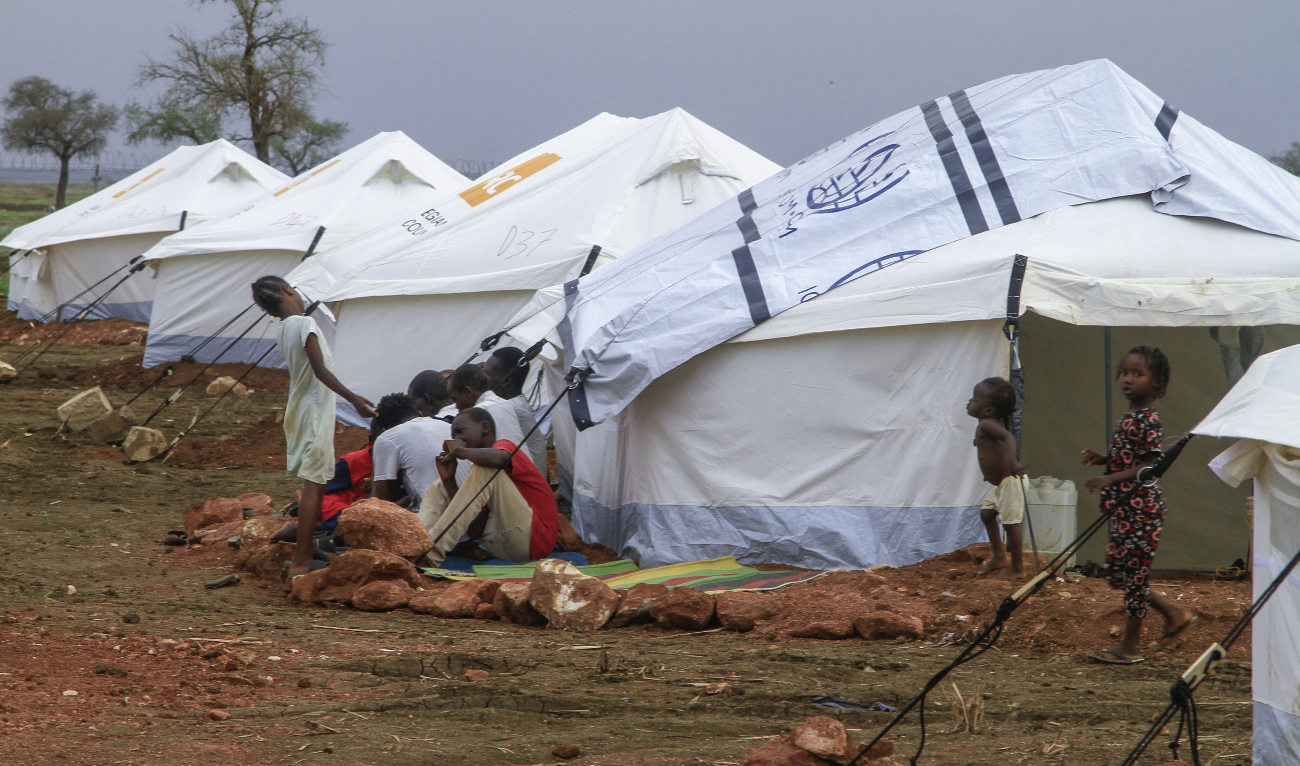 Displaced people gather outside their tent in a recently set up camp for internally displaced Sudanese from Sennar state, in the Al-Huri district of Gedaref city in the east of war-torn Sudan on July 14, 2024. (AFP)