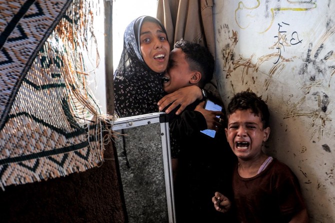 Children react after Israeli bombardment as they take refuge at the Jaouni school run by the UN Relief and Works Agency for Palestine Refugees (UNRWA) in Nuseirat in the central Gaza Strip on July 6, 2024 amid the ongoing conflict in the Palestinian territory between Israel and Hamas. (AFP)