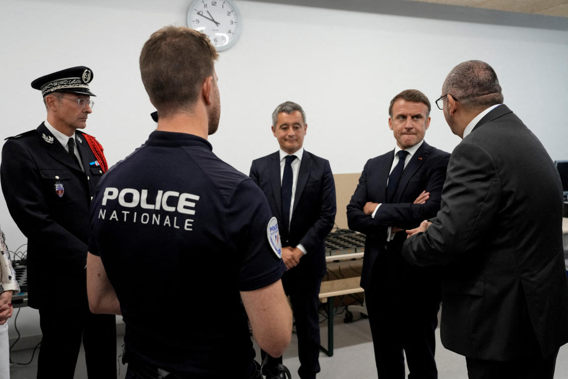 French President Emmanuel Macron and Interior Minister Gerald Darmanin listen to Paris police Prefect Laurent Nunez on a visit to the police station of the Olympic village for the 2024 Summer Olympics, in Paris, on Jul. 22, 2024. (Reuters)