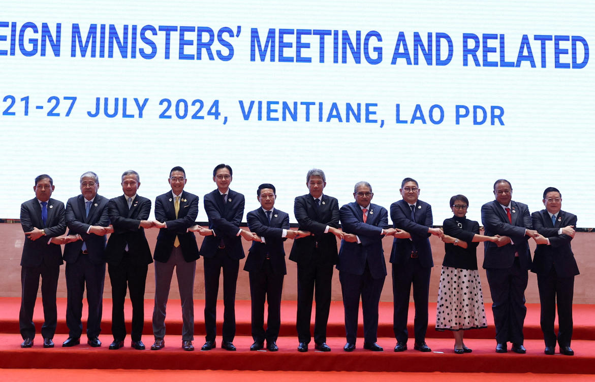 ASEAN foreign ministers pose for a family photo on the day of the 57th ASEAN Foreign Ministers’ Meeting at the National Convention Center in Vientiane, Laos on July 25, 2024. (Reuters)