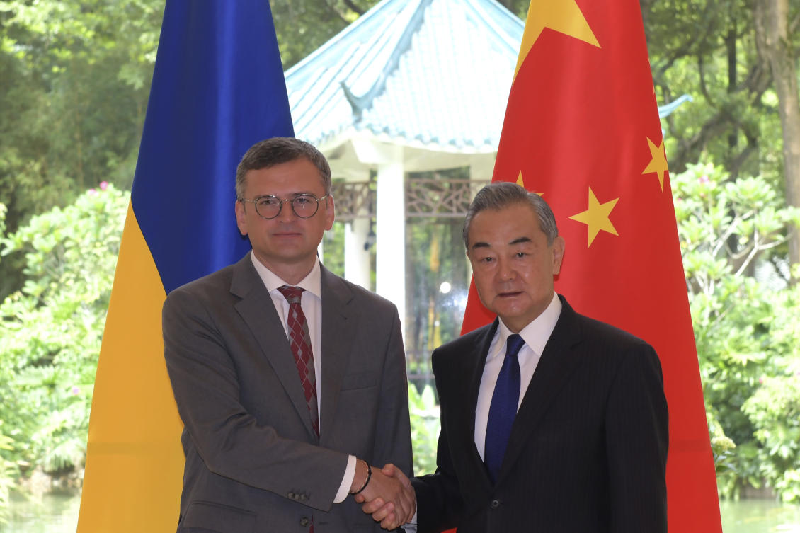 In this photo released by Xinhua News Agency, Ukraine’s Foreign Ministry Dmytro Kuleba, left, poses for photos with China’s Foreign Minister Wang Yi before a meeting in the southern Chinese city of Guangzhou on Jul. 24, 2024. (AP)