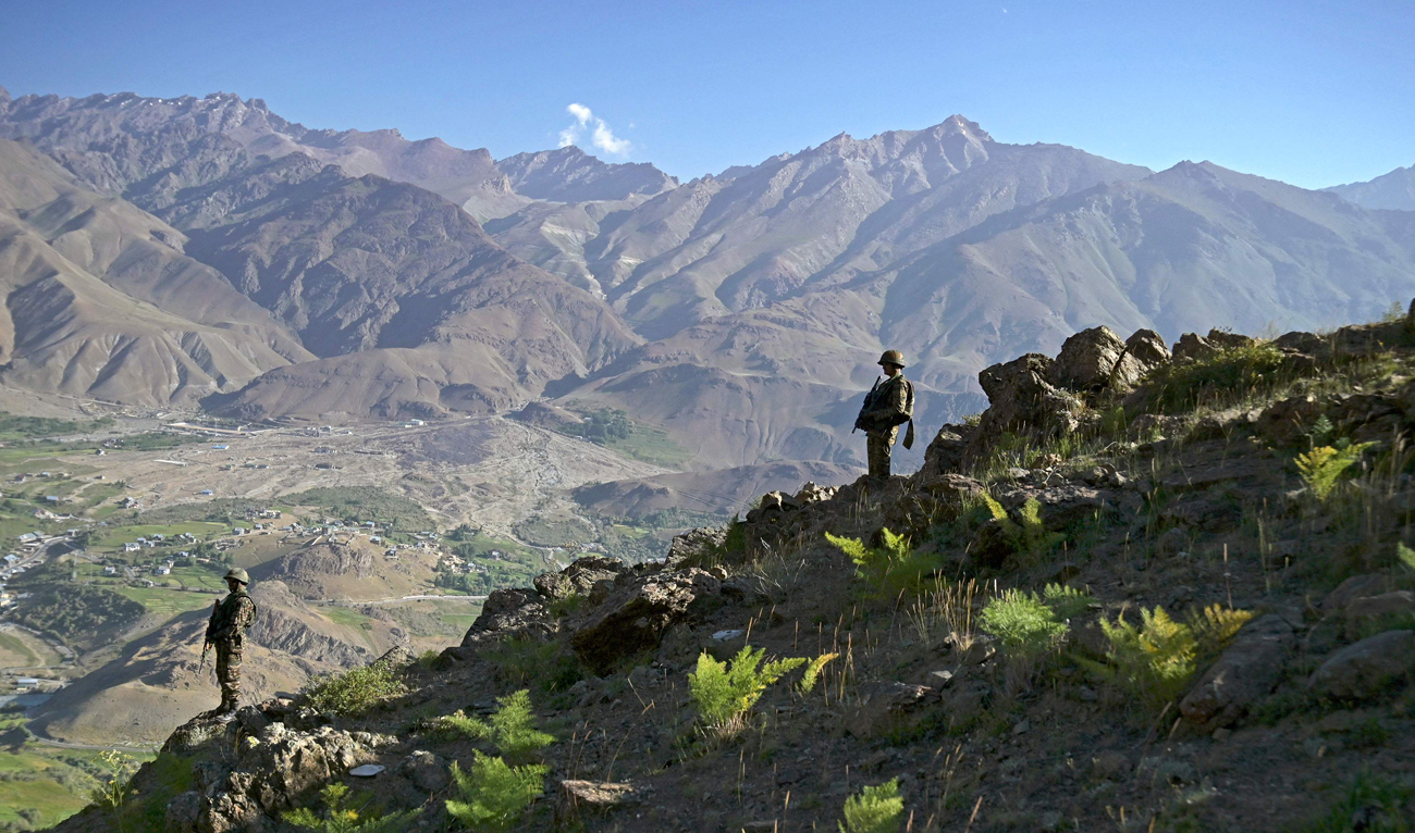 Indian army soldiers stand guard on Lamochan mountain overlooking settlement at Drass, Kargil district on July 25, 2024. (AFP)