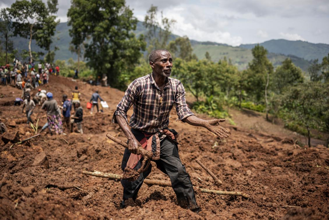 A man reacts as residents and volunteers dig in the mud in search for bodies at the scene of a landslide in Kencho Shacha Gozdi on July 25, 2024. (AFP)