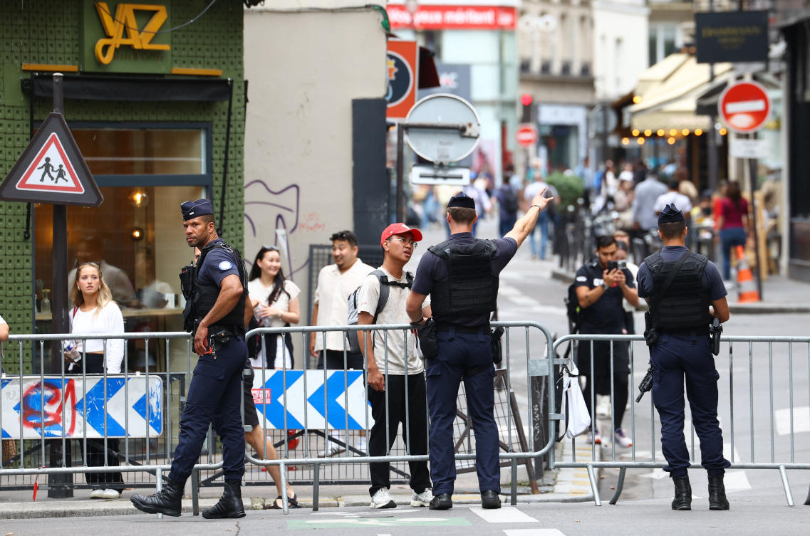 Police personnel are seen nearby the Seine river as the security perimeter for the opening ceremony is deployed ahead of the Paris 2024 Olympics on July 26, 2024. (Reuters)
