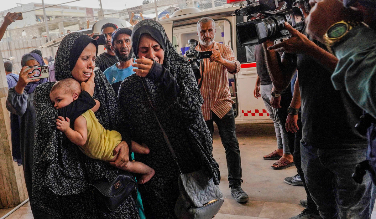 Bystanders and reporters film outside the Nasser hospital, where the injured and dead arrive following the Israeli targeting the southeastern district of Khan Yunis, in the southern Gaza Strip, on July 25, 2024, amid the ongoing conflict between Israel and the Palestinian militant group Hamas. (AFP)
