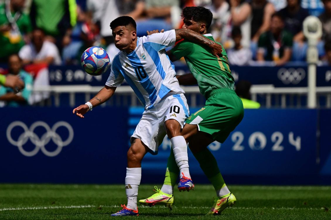 Argentina’s midfielder #10 Thiago Almada fights for the ball with Iraq’s defender #17 Mustafa Saadoon in the men’s group B football match between Argentina and Iraq during the Paris 2024 Olympic Games at the Lyon Stadium in Lyon on July 27, 2024. (AFP)