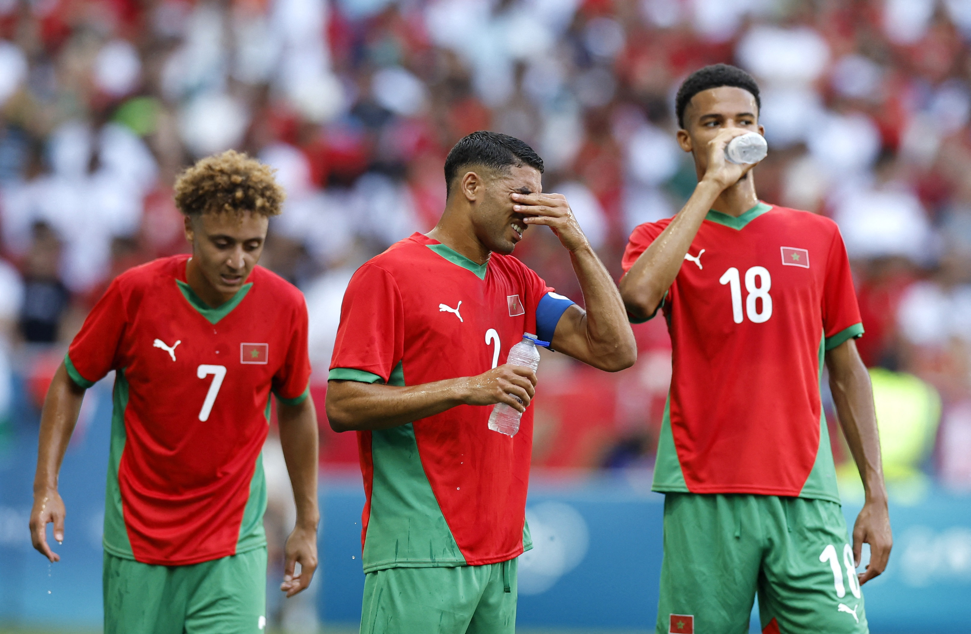 Morocco players react after they were caught by a 98th-minute sucker punch against Ukraine in the Olympics football on Saturday. (Reuters)