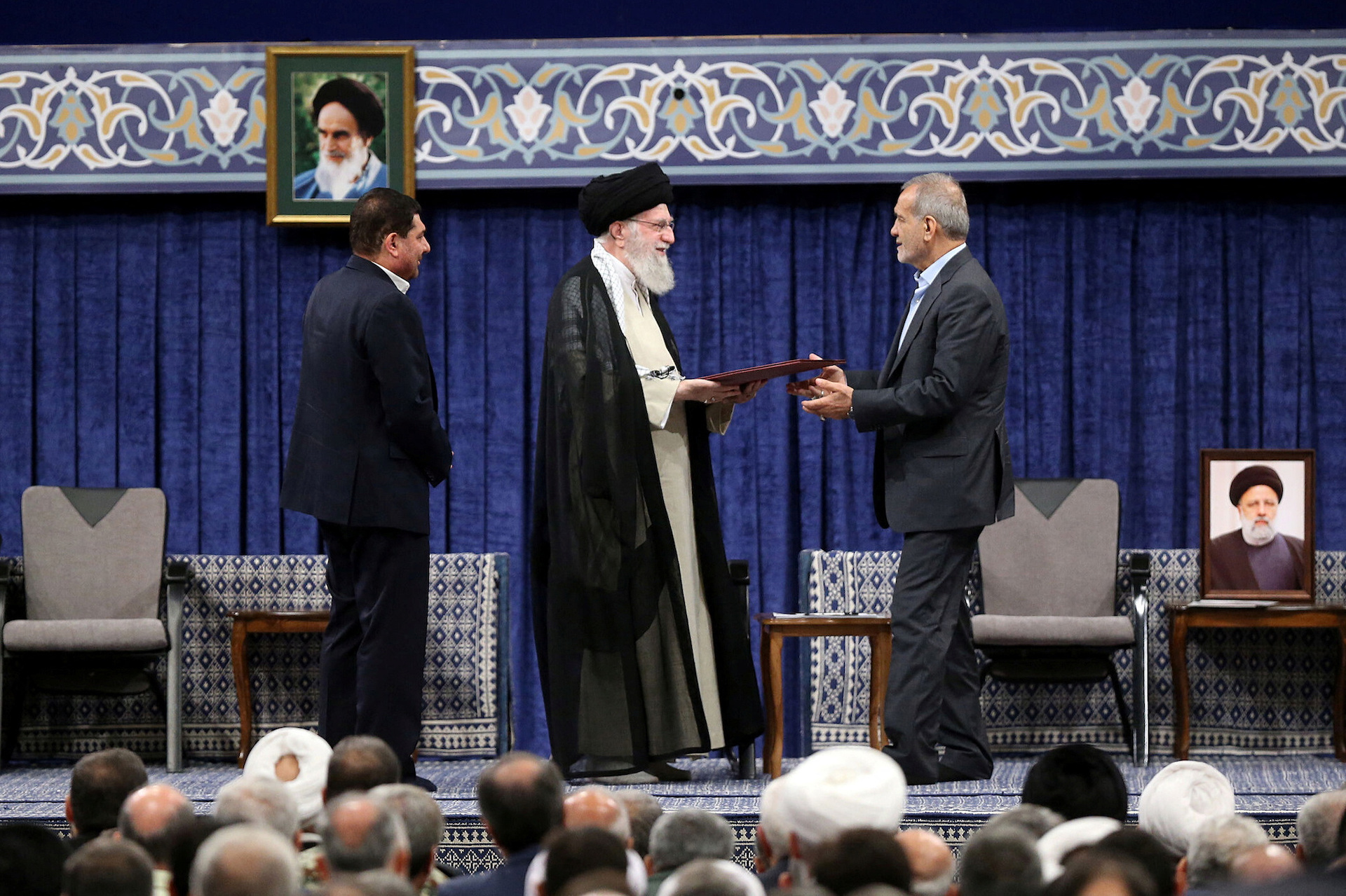 Iran's Supreme Leader Ayatollah Ali Khamenei gives a Presidential decree to Iran's new president, Masoud Pezeshkian, during an endorsement ceremony in Tehran, Iran, July 28, 2024. (Reuters)