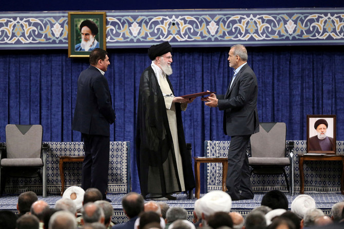 Iran's Supreme Leader Ayatollah Ali Khamenei gives a Presidential decree to Iran's new president, Masoud Pezeshkian, during an endorsement ceremony in Tehran, Iran, July 28, 2024. (Reuters)