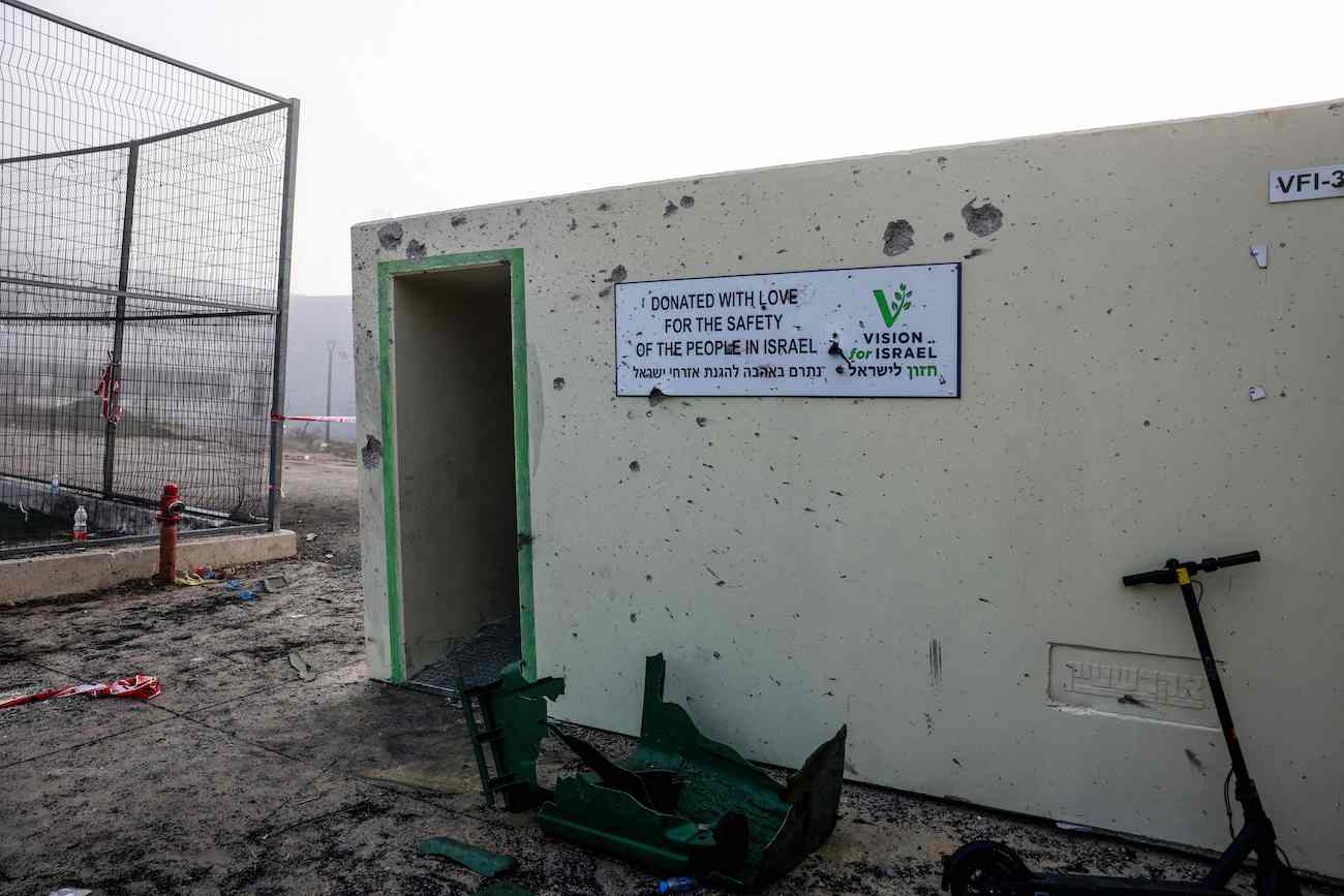 Objects are scattered in front of a shrapnel-poked wall at a sports facility a day after a rocket strike from Lebanon that Israeli authorities said killed 12 people. (AFP)