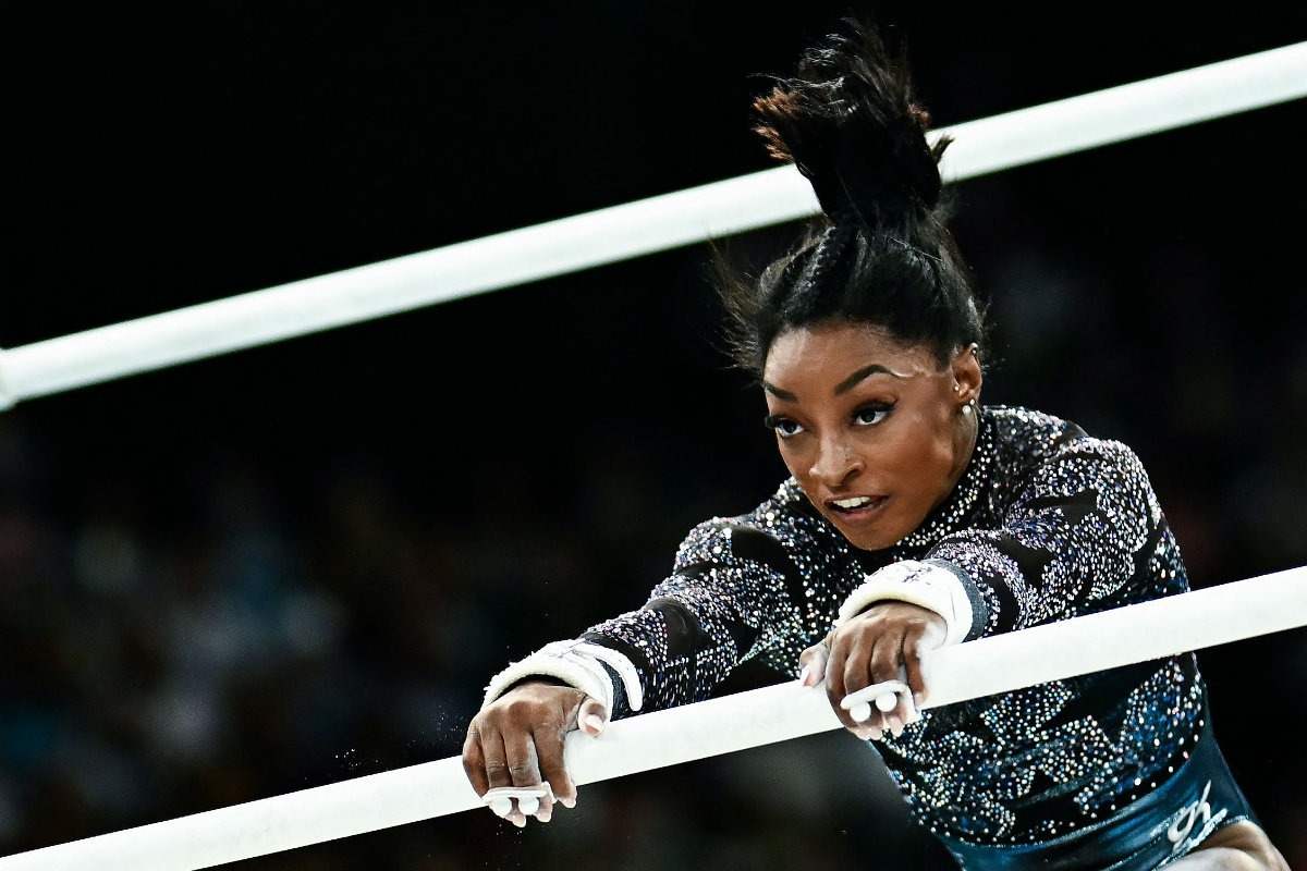 US' Simone Biles competes in the uneven bars event of the artistic gymnastics women's qualification during the Paris 2024 Olympic Games at the Bercy Arena in Paris, on July 28, 2024. (AFP)