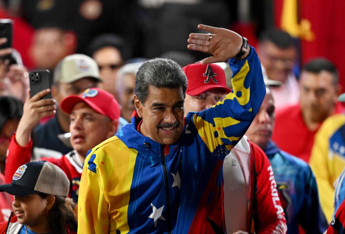 Venezuela's President Nicolas Maduro won reelection with 51.2 percent of votes cast Sunday, the electoral council announced, after a campaign tainted by claims of opposition intimidation and fears of fraud. (AFP)