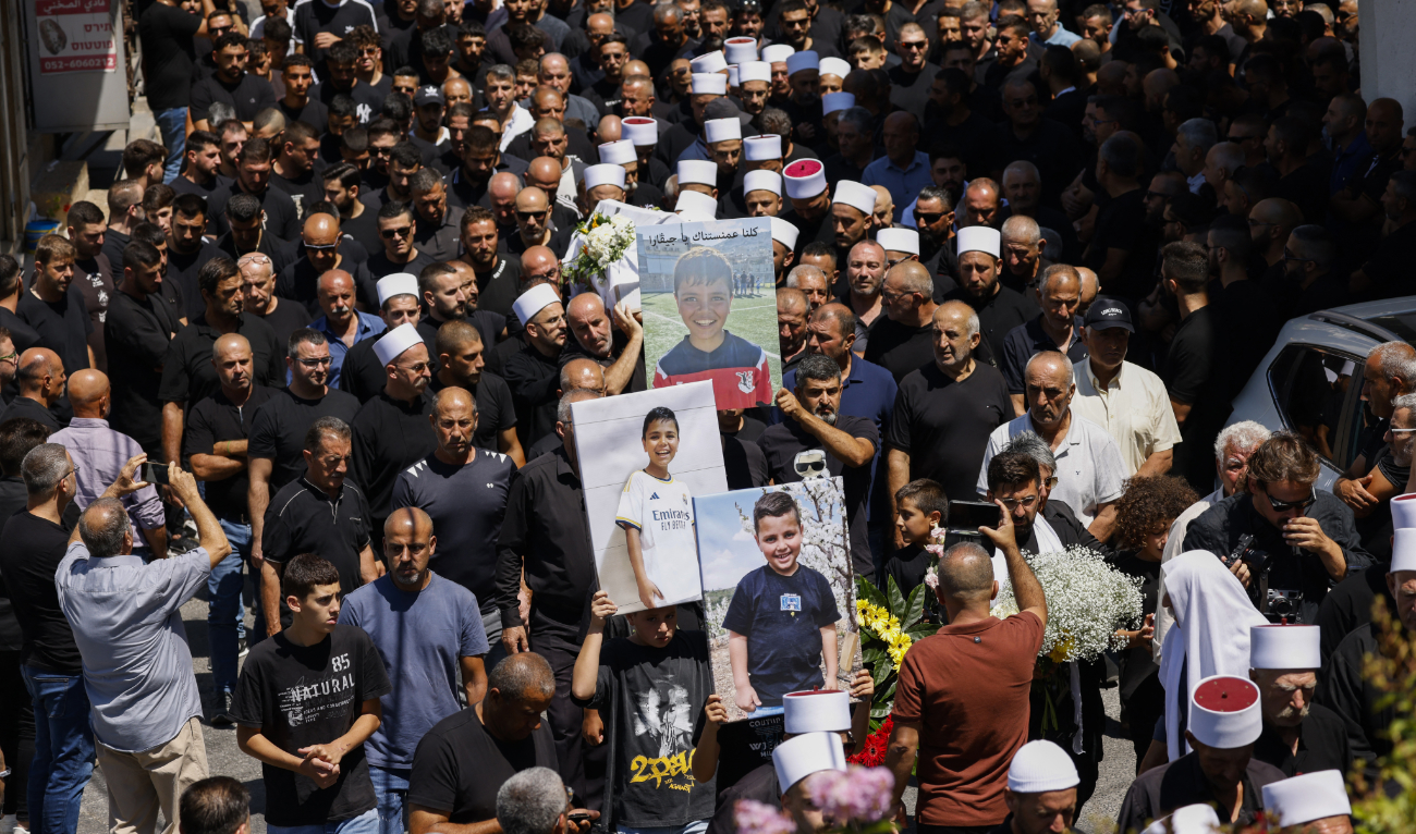 Elders and mourners carry the coffin of Guevara Ibrahim, 11, killed in a reported strike from Lebanon two days earlier, during his funeral in the town of Majdal Shams in the Israeli-annexed Golan on July 29, 2024. (AFP)