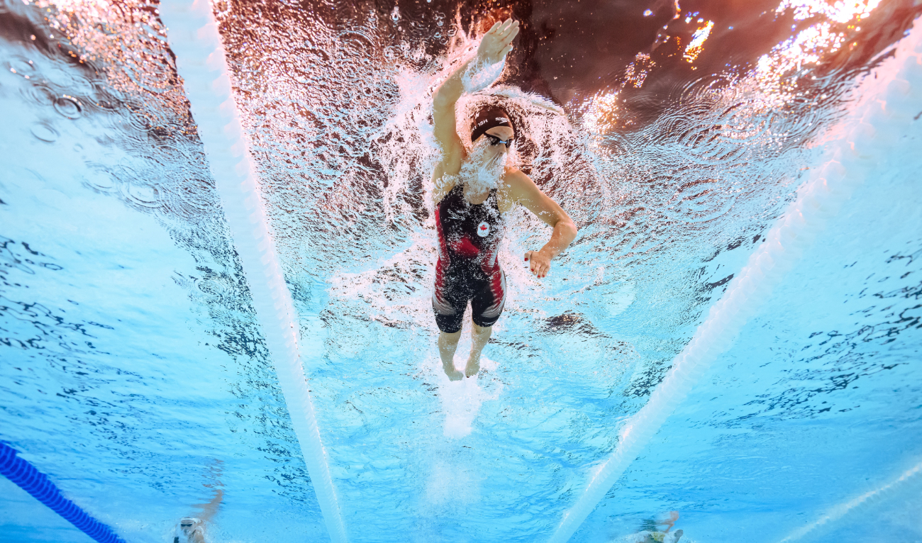 An underwater view shows Canada’s Summer McIntosh competing in the heats of women's 400m individual medley swimming event during the Paris 2024 Olympic Games at the Paris La Defense Arena in Nanterre, west of Paris, on July 29, 2024. (AFP)