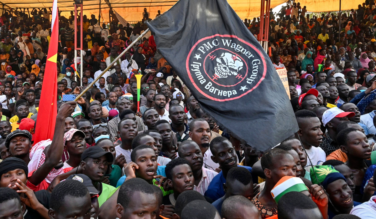 Supporters of Niger's National Council of Safeguard of the Homeland (CNSP) wave a flag bearing the logo of private military Company (PMC) Wagner, as they protest ouside the Niger and French airbase to demand the departure of the French army from Niger, in Niamey on September 16, 2023. (AFP)