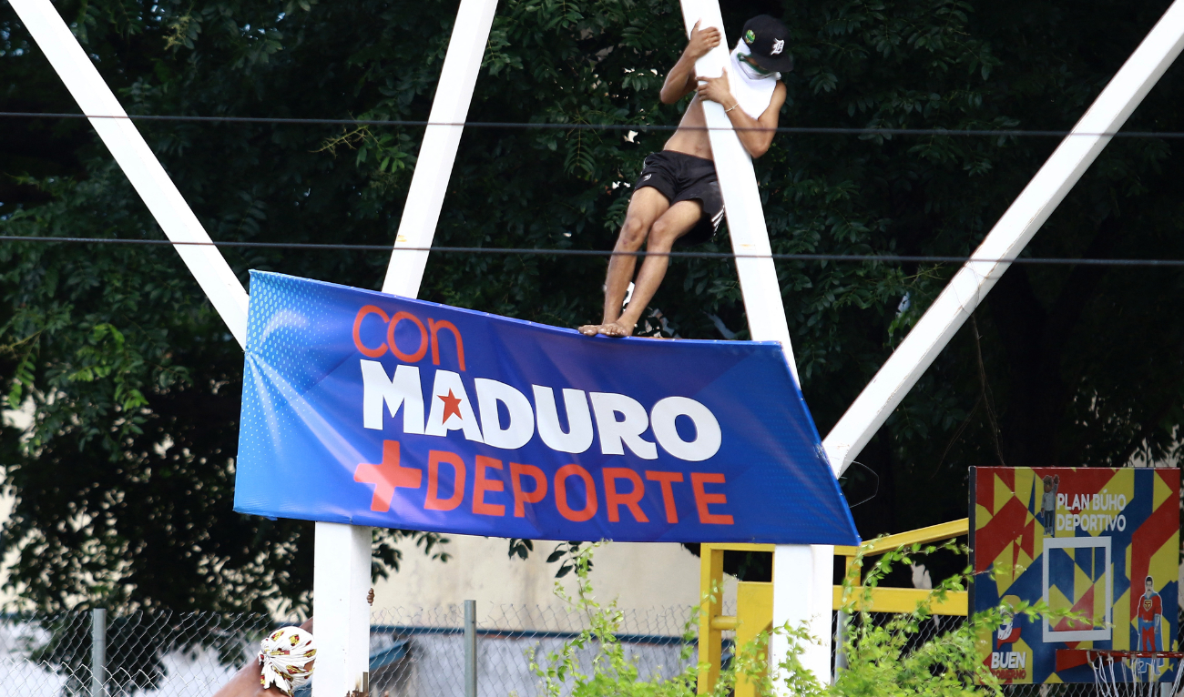 Demonstrators disassemble a banner during a protest against Venezuelan President Nicolas Maduro's government in Valencia, Carabobo state, Venezuela on July 29, 2024. (AFP)