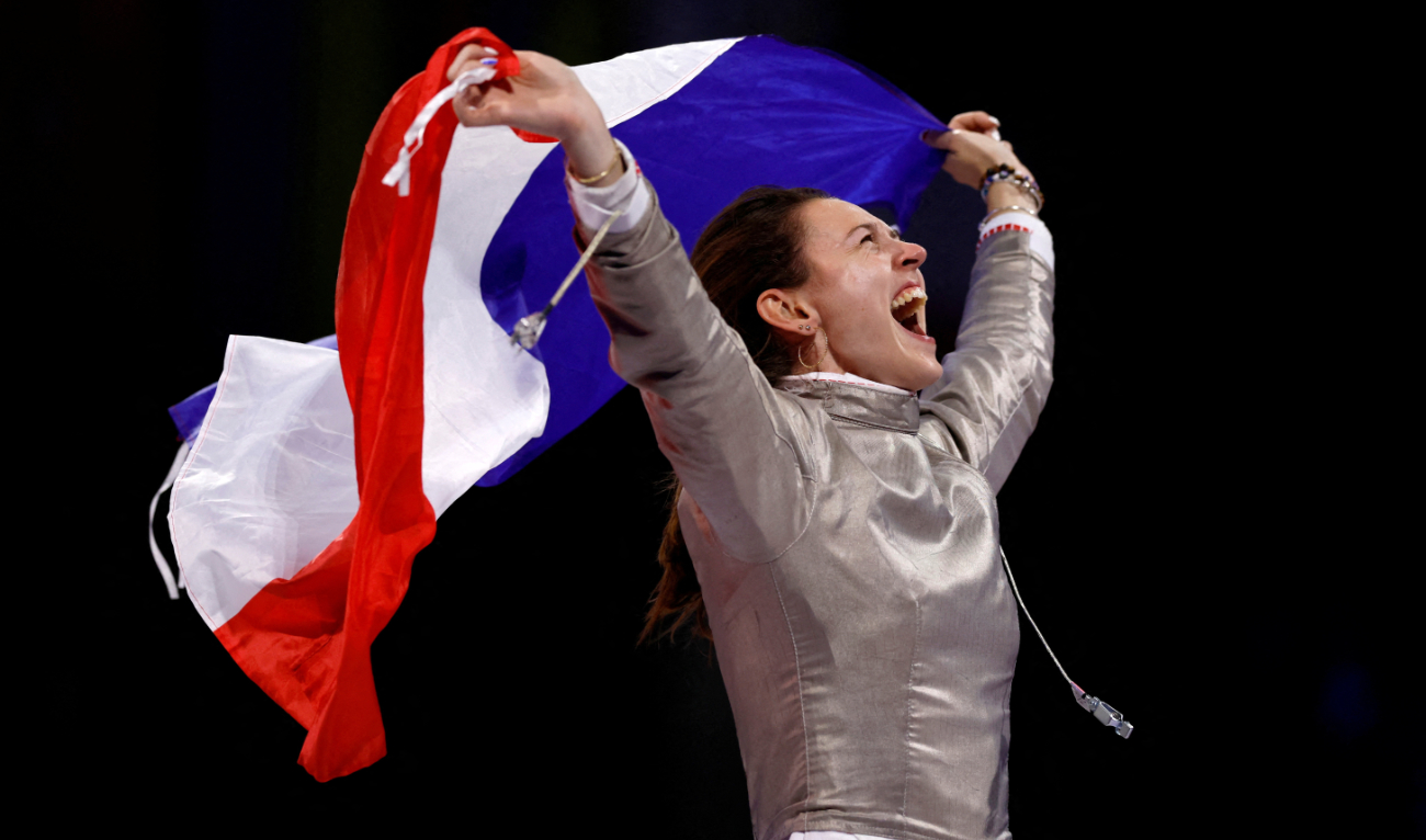 Manon Apithy-Brunet of France celebrates with flag after winning her gold medal bout against countrywoman Sara Balzer. (Reuters)