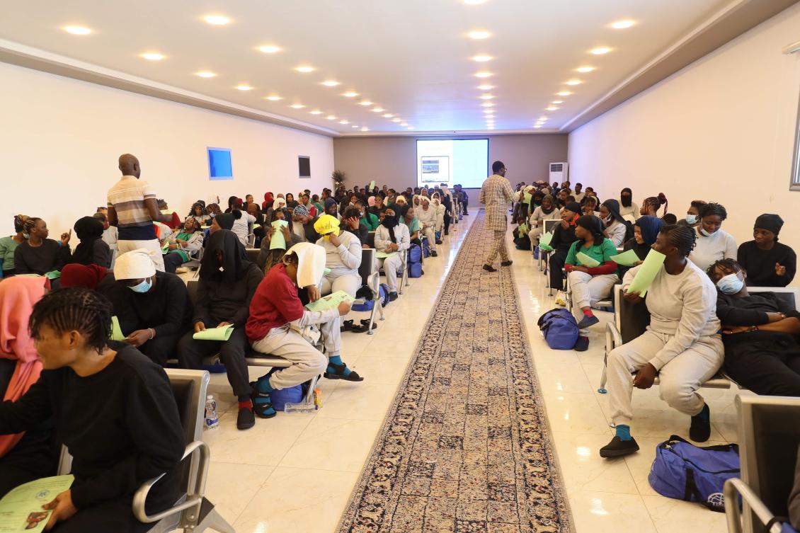 Irregular Nigerian migrants, who voluntarily agreed to be deported by home, sit waiting at the anti-migration bureau, tasked with coordinating deportations of foreigners who are in the country illegally, befotre departing to Mitiga International Airport in Tripoli on Jul. 30, 2024. (AFP)