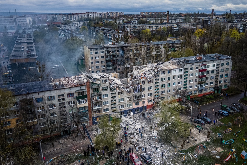 rescuers on top of a partially destroyed residential building, after a shelling in Sloviansk. (AFP)