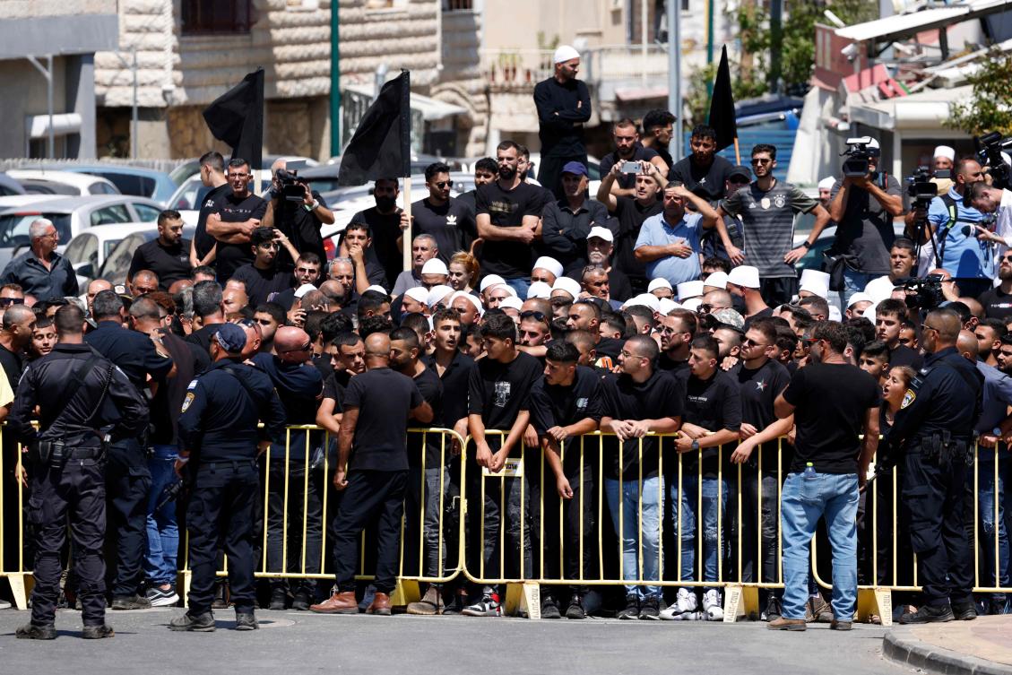 Israeli security hold back demonstrators during a visit by the Israeli Prime Minister two days after a rocket crashed killing 12 youngsters in the Druze village of Majdal Shams in the Israeli annexed Golan Heights, on July 29, 2024. (AFP)