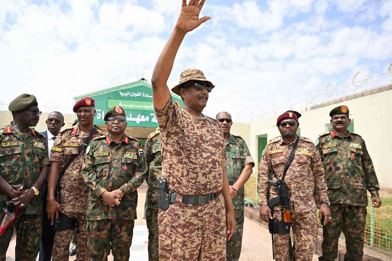 Sudan’s army chief Abdel Fattah Al-Burhan (C) waves during a graduation ceremony in Gibet near Port Sudan on July 31, 2024. (AFP)